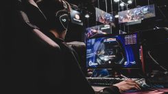 person sitting on gaming chair while playing video game