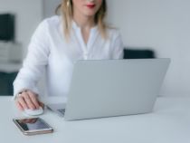 Woman using laptop with wireless mouse